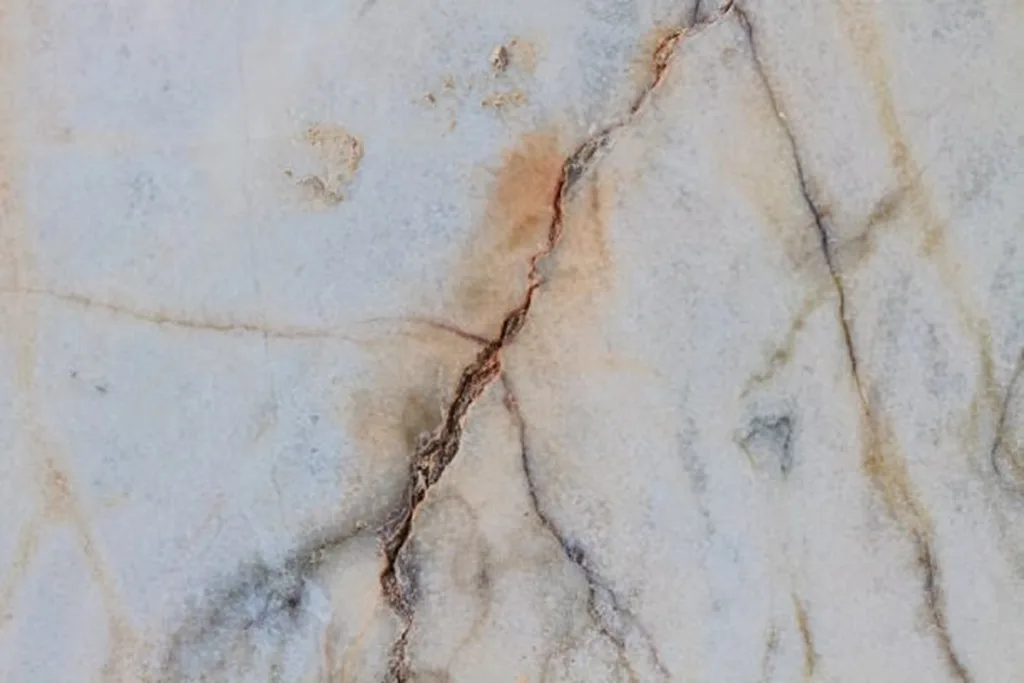 Light-colored granite with visible cracks.