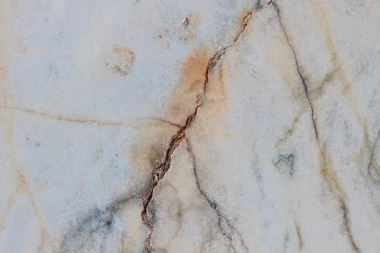 Light-colored granite with visible cracks.